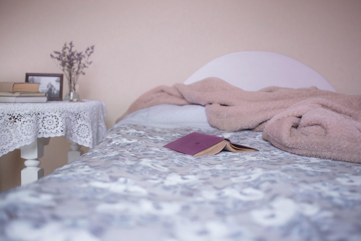 A bedroom with the bed set at a height that allows feet to reach the floor