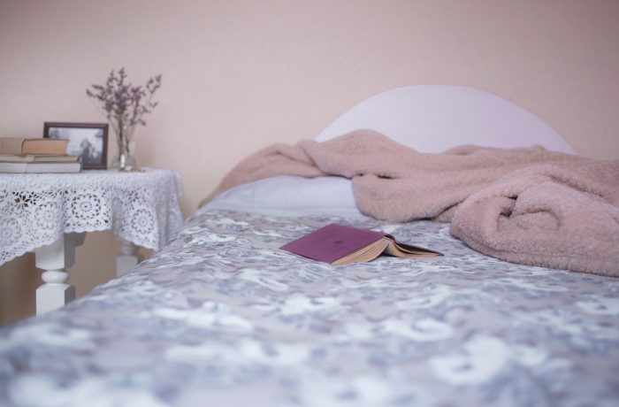 A bedroom with the bed set at a height that allows feet to reach the floor