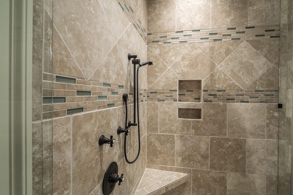 A tiled shower enclosure wall, the surface a grab bar has to be anchored through