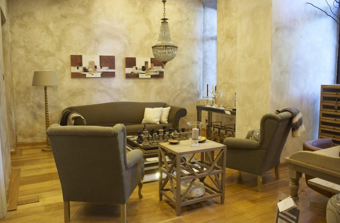 A living room with an armchair beside a low table