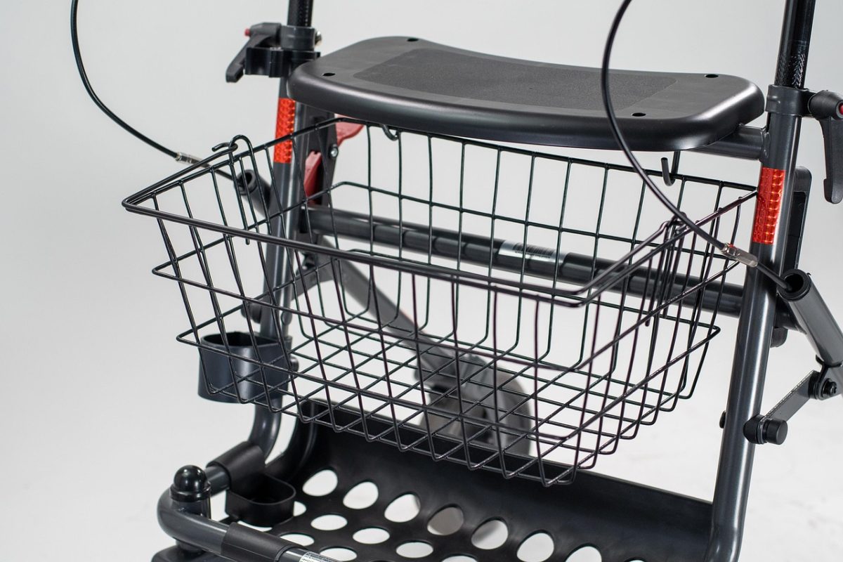 A four-wheeled rollator walking frame with hand brakes and a seat