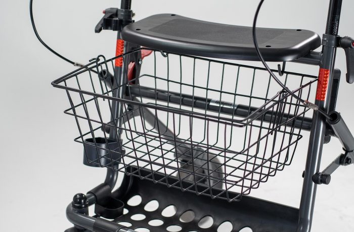 A four-wheeled rollator walking frame with hand brakes and a seat