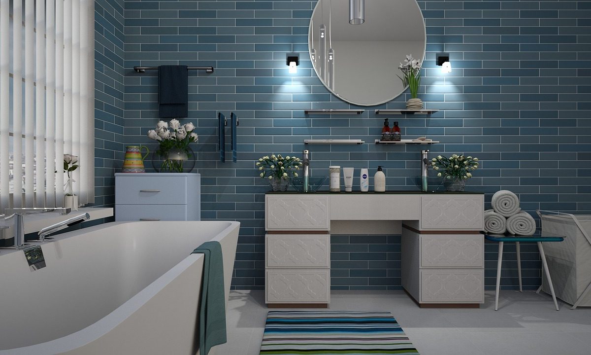 A bathroom with a tiled floor and bathtub, the surfaces a shower chair has to grip
