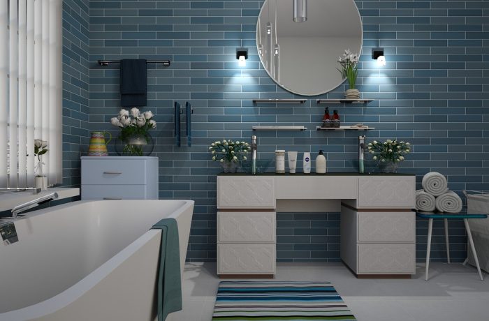 A bathroom with a tiled floor and bathtub, the surfaces a shower chair has to grip